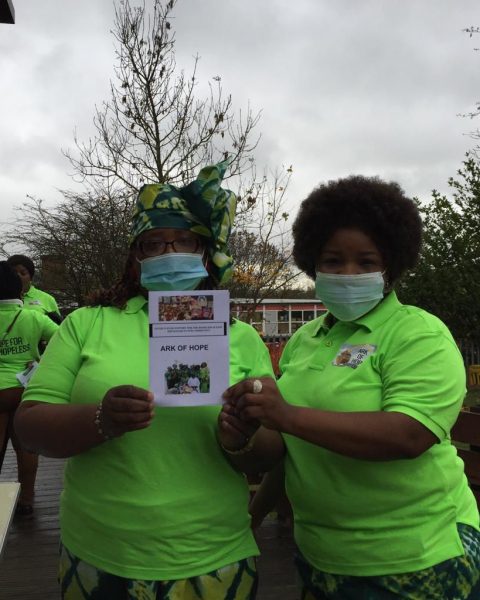 Tosin and Deola holdind up ark of hope leaflets