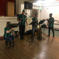 Entertainment provided for the Veteran Fundraiser last year. A band of a singer a tradition african drummer and Me (gabriel) walking around awkwardly setting up on the stage for their performance.