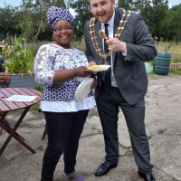Tosin with the Mayor of Tameside at fundraising event in 2019 Tosin eating chicken with the Mayor of Tameside