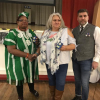 Descendants of the awardees at the veterans fundraiser event Tosin and 2 other veteran descendants are posing with their medals on stage