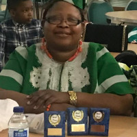 The medals that were given out during the venet Tosin sitting behind 3 blue standing medals
