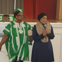 Tosin with Rihanna (an asian community leader in the are) at the Veterans Fundraiser Tosin carrying a drum looking shocked while Rihanna is standing for a picture next to her