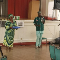 MC Otumba who was calling out donations The MC of the event is calling for donations, whilst an usher is holding out the donations tray
