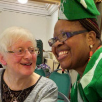Tosin smiling with an old white lady